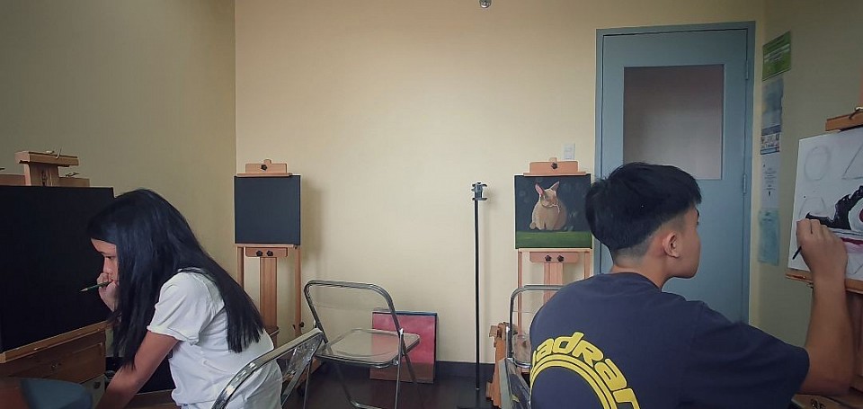 Alexi, grade 12, ISM. Nick, ateneo. Siblings working on their paintings.