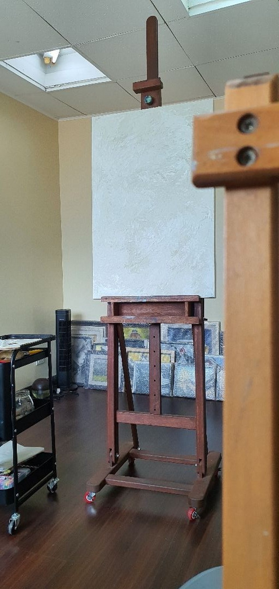 Students work on professional studio easels that allow them to develop proper working posture and control while drawing and painting.