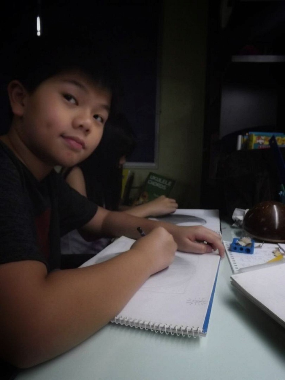 The first lessons were not held in a formal studio. They began as small art sessions taught in students' homes, where a few young learners gathered to draw, experiment with materials, and explore their curiosity about art.